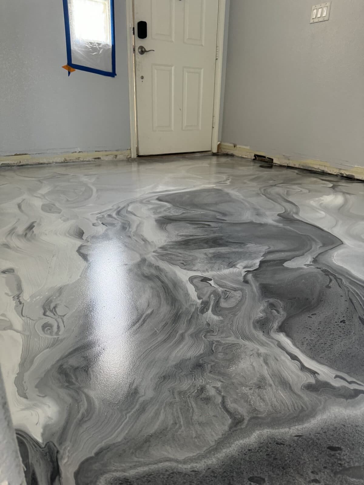 Commercial-grade urethane topcoat on metallic epoxy floor showing satin texture for traction — installed by ProShield Epoxy in Las Vegas