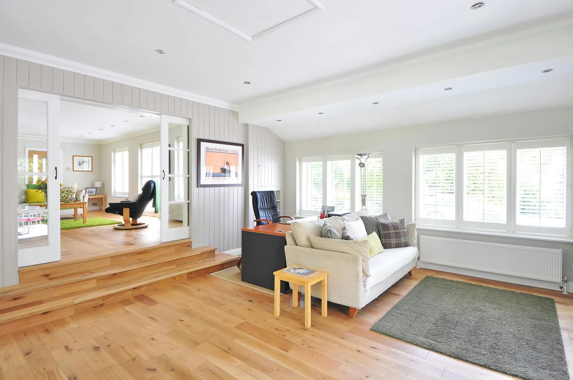 Bright living room with warm wood plank flooring throughout