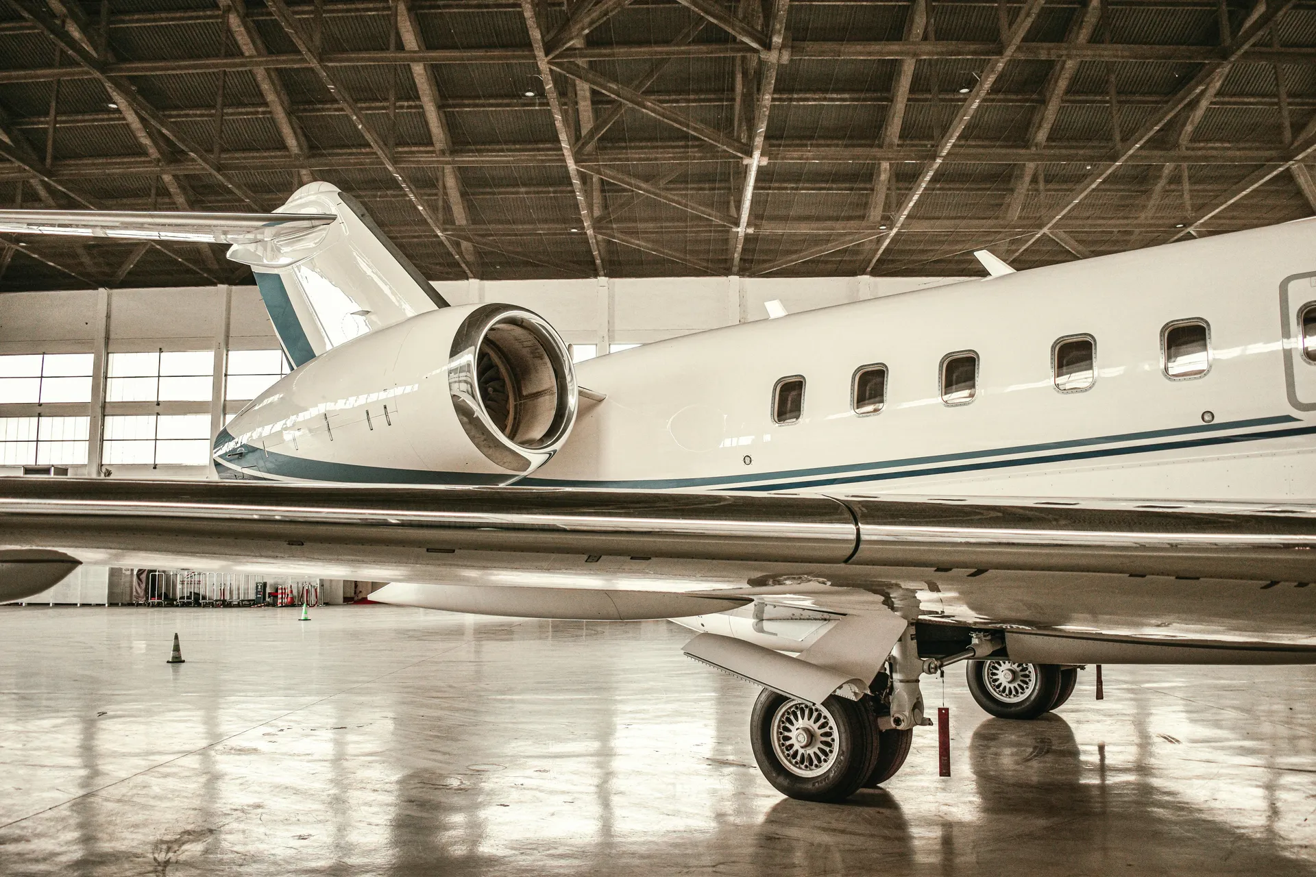 Private jet on a high-gloss coated hangar floor