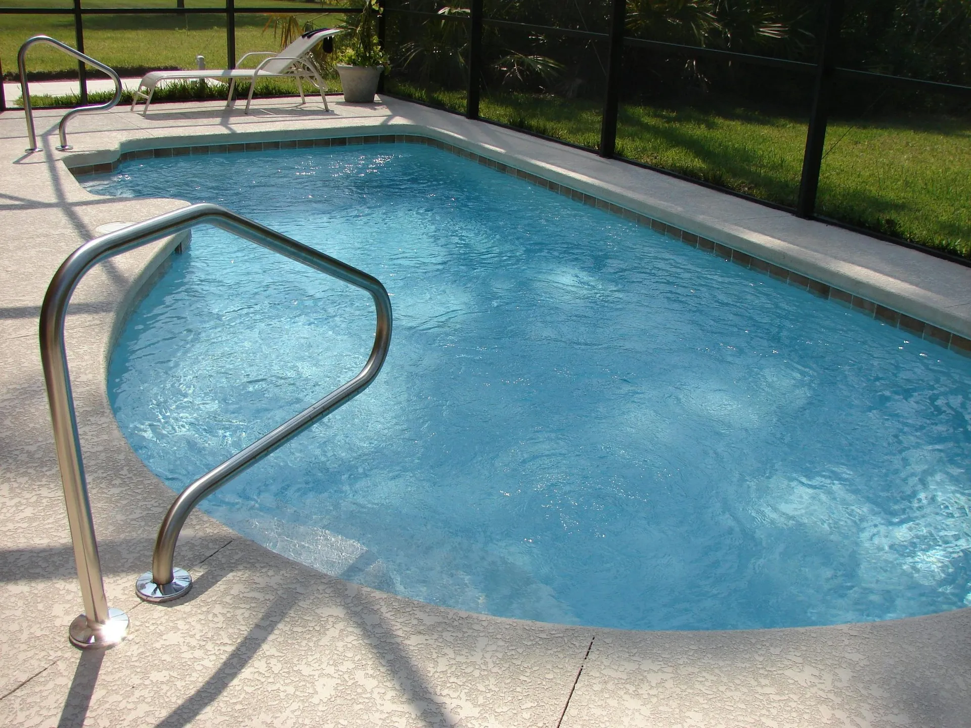 Beautiful pool deck with cool deck coating in a residential backyard