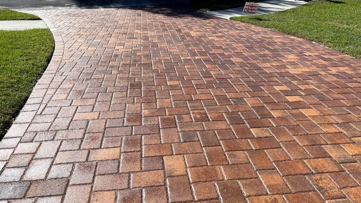 Glossy sealed brick paver driveway with rich color enhancement