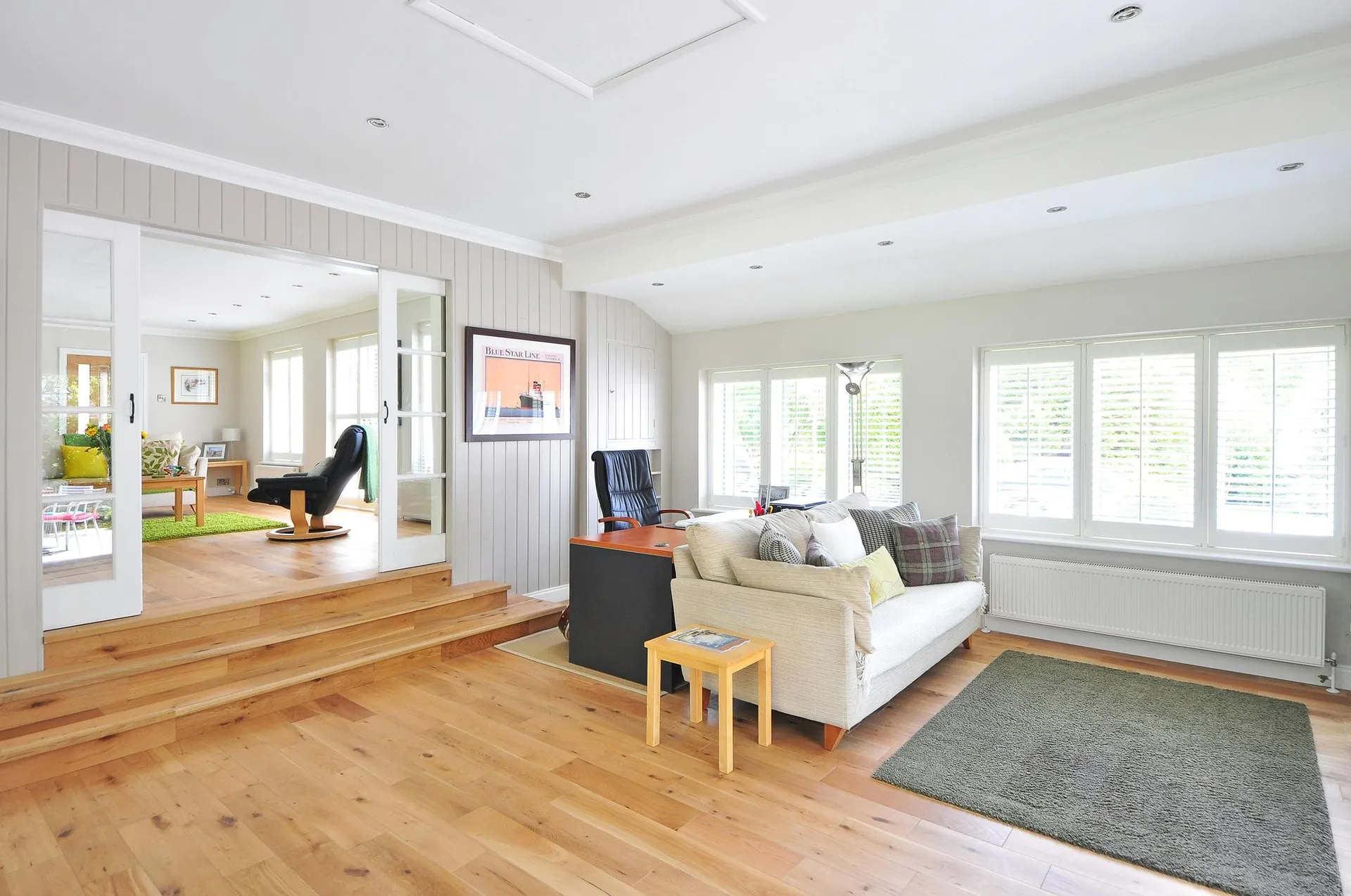 Bright living room with warm wood plank flooring throughout