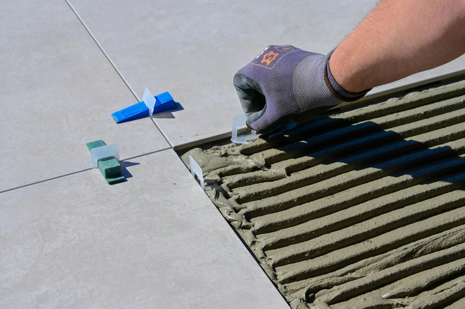 Professional tile installation — laying tile with thinset and levelers